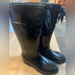 See by Chloe black rain boots with lace up detail.